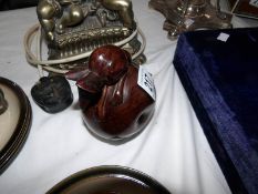 A carved wooden apple with a mouse on top.