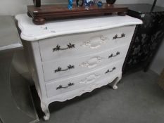 A white painted French style 3 drawer chest.