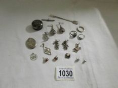 A mixed lot of silver items including locket, earrings, charms etc.