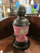 A Victorian oil lamp with glass font.