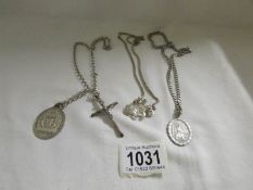 3 silver chains with crucifix, medallion and bull dog fobs.