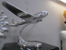 A silver coloured model airplane.