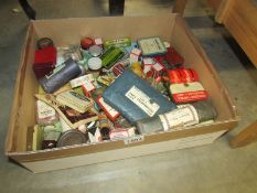 A box of tins and packaging of a domestic medical nature.