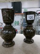 A pair of carved stone vases.