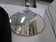 An oval bevel edged mirror