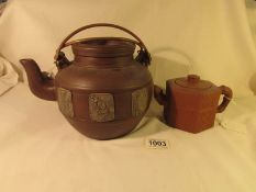 A large Yixing clay teapot and a 19th century signed Yixing teapot.