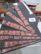 A collection of penny red stamps.