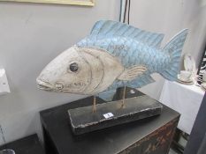 A large wooden fish ornament.