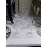 A cut glass decanter and 10 cut glass wine goblets.