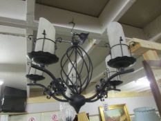 A wrought iron ceiling light with Murano glass shades.