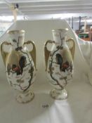 A pair of 19th century German porcelain vases hand decorated with birds, one a/f.