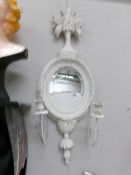 A shabby chic mirror with candle sconces.