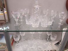 A quantity of crystal glasses and a decanter.