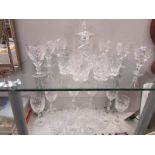 A quantity of crystal glasses and a decanter.