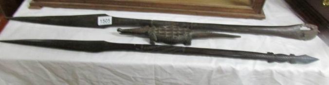 2 tribal weapons and a carved wood crocodile.