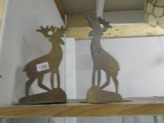 A pair of brass arts and crafts deer fireside dogs.