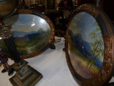 A pair of oval framed and glazed oil painting, rural scenes.