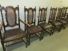 A set of 6 Edwardian oak dining chairs with cane backs.