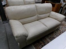 A cream leather 3 seat sofa.
