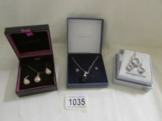 3 boxed pendant and earring sets.