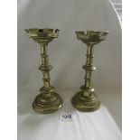 A pair of heavy brass Eccliastical candlesticks