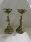 A pair of heavy brass Eccliastical candlesticks