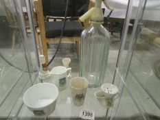 6 items of crested china and a soda syphon.