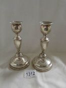 A pair of silver candlesticks, London 1915.