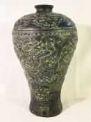 An Eastern bronze vase decorated with dragons, signed.