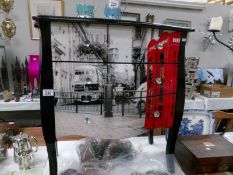 A 3 drawer chest depicting a London street scene.