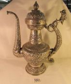A Persian white metal ewer with dragon form handle,