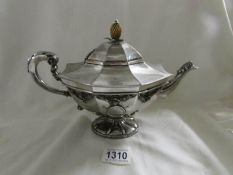 An ornate silver teapot in Adam style with pineapple knob, London 1909, approximately 800 grams.