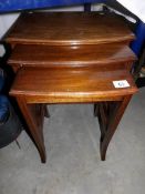 A nest of 3 mahogany tables.