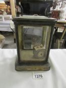 A large brass carriage clock case and a small brass clock.