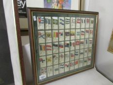 A framed and glazed set of silk cigarette cards of flags.