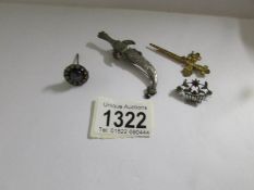An unusual 'Crucifix' stick pin, a sword brooch,