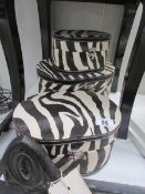 3 oval zebra print storage boxes.