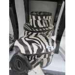 3 oval zebra print storage boxes.