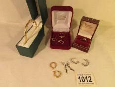 A mixed lot of white and yellow gold jewellery including bangle, earrings, rings.