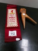 An embroidered book mark and a wood nutcracker.