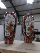 A pair of tall Imari vases, one a/f.