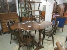 An oak dining table and 5 chairs.