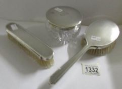 2 silver backed brushes, London 1946/47, Mappin & Webb and a silver topped glass powder bowl,