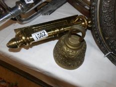 A brass letter box and a brass bell.