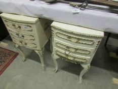 A pair of French style bedside cabinets.