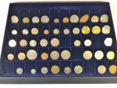 A collector's tray of mainly foreign coins.