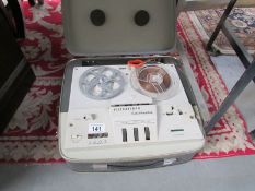 A vintage reel to reel tape recorder.