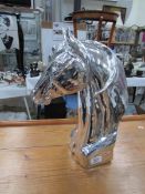 A silver coloured horse head.