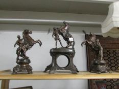 A spelter clock case surmounted horse with a pair of Marley style horse side pieces.