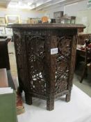 An ornately carved oriental table.